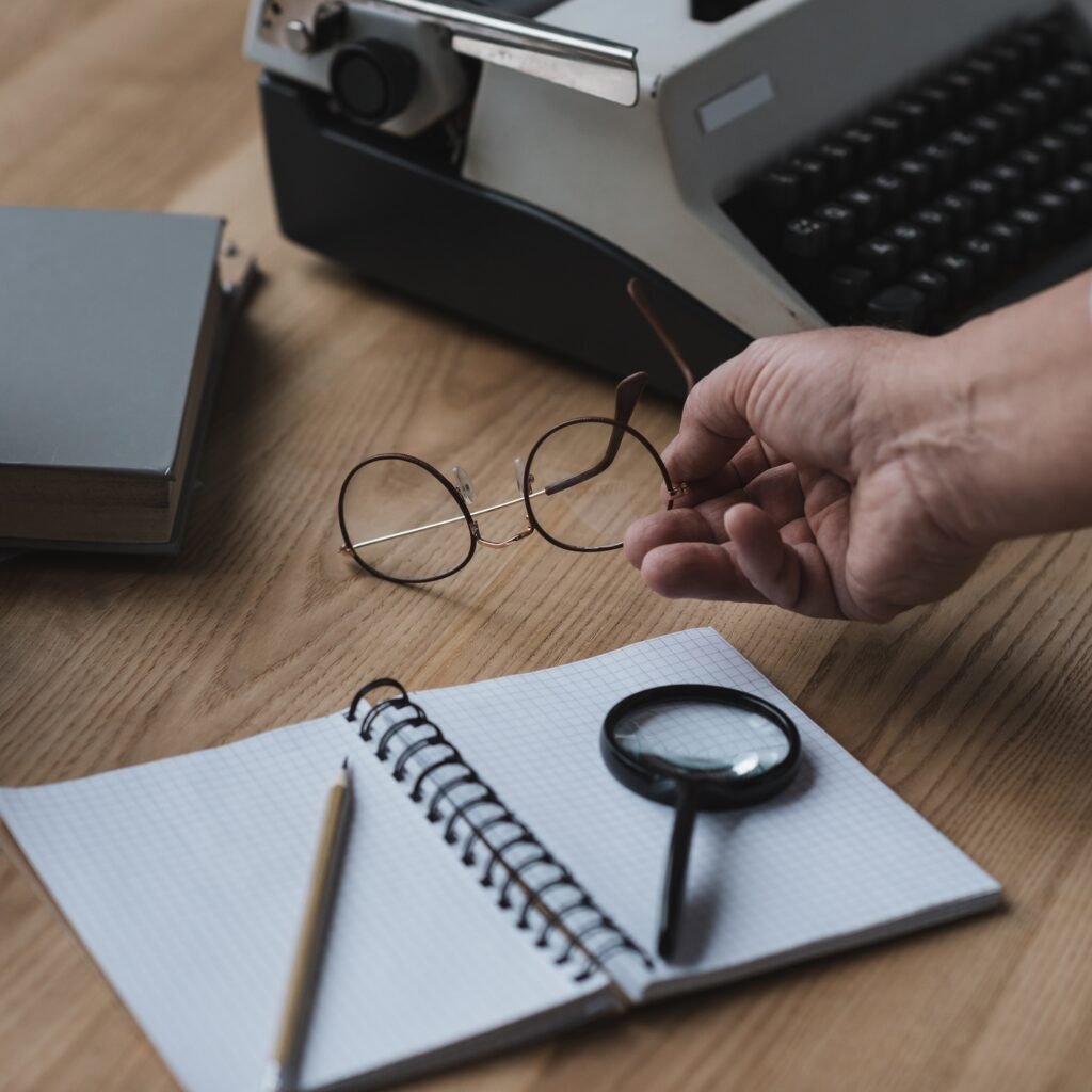 Social media copywriting: how agencies create posts that go viral. Senior Writer Putting Eyeglasses On Work Desk W7GAV6Z 1024x1024